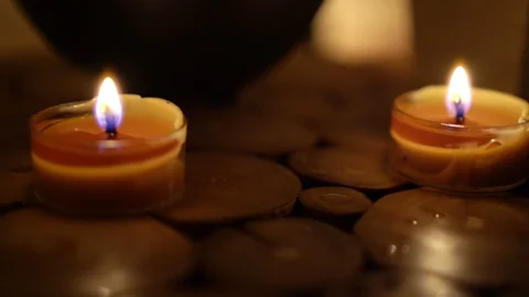 Close-up of burning tealight candle on table in home. Stock Footage 129299548