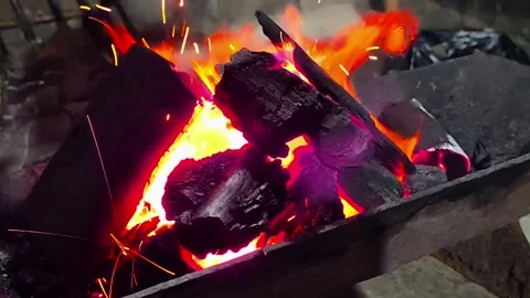 Close-up of burning wood producing a large flame. 4K Stock Footage 338433028