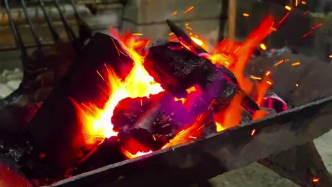 Close-up of burning wood producing a large flame. 4K Stock Footage 338433046