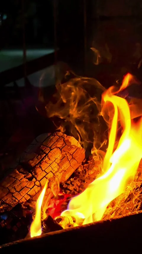 Close-up of burning wood producing a large flame. 4K Stock Footage 338433079