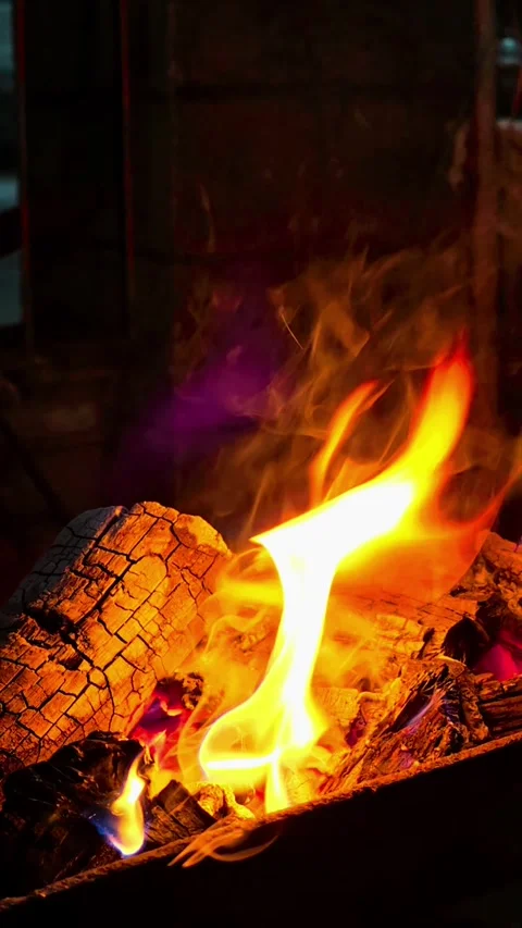 Close-up of burning wood producing a large flame. 4K Stock Footage 338433100