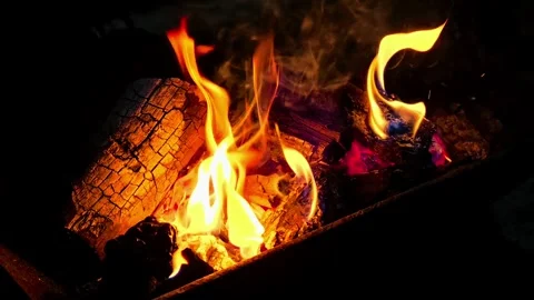 Close-up of burning wood producing a large flame. 4K Stock Footage 338433872