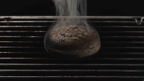 Close up of burnt bread inside the oven with metal bars on black background 動画素材 145793371