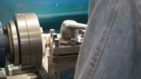 Close up of bushing making on old shabby blue lathe, metal shavings flying. Stock Footage 81517790