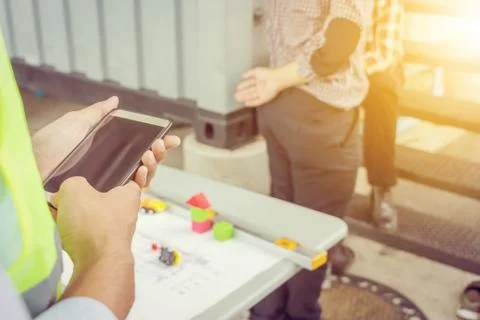 Close up of business engineer man using mobile smartphone construction site Фото