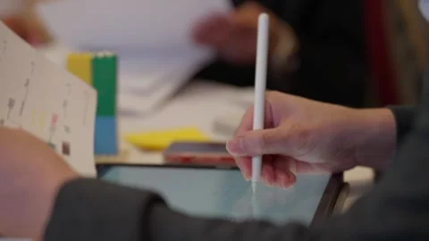 Close-up of Business Hand Using Stylus on Tablet in Meeting Stock Footage 311758416