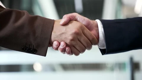 Close up of business handshake symbolizing teamwork and cooperation. Two male  Stock Footage 303411875