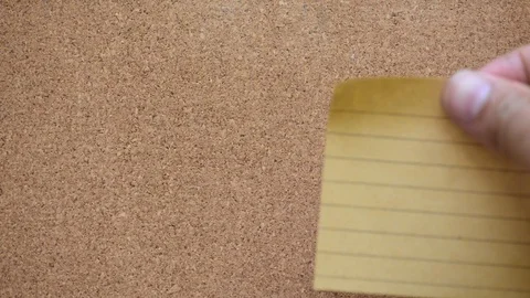 Close up of business man hand sticking empty paper on cork board Stock Footage