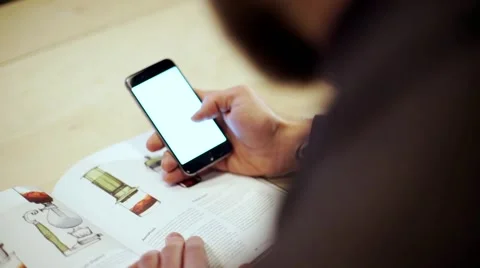 Close-up business man is using smart phone and read magazine in cafe Stock Footage 56892106