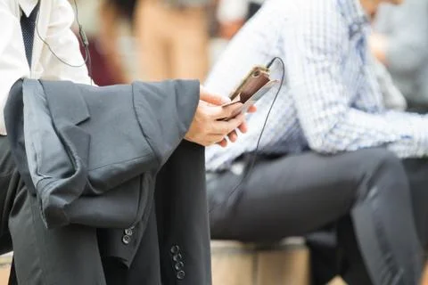 Close up of  business man's hand which holding mobile phone and have headphon Stock Photos