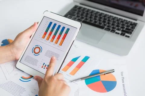 Close-up of business person using digital tablet with financial diagram Stock Photos