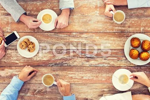 Close Up Of Business Team Drinking Coffee On Lunch