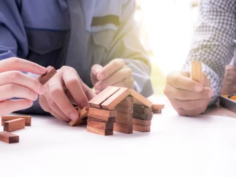 Close Up of business team making a structure with wooden cubes. Building a bu Stock Photos