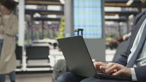 Close up of business traveler using notebook in bus terminal during work trip Stock Photos