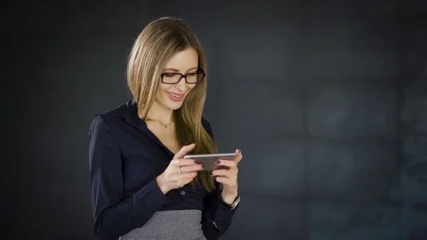 Close up of business woman standing in the office with dark grey wall in the Stock Footage