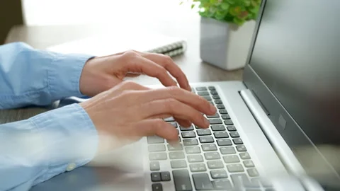 Close-up of a business woman's hands working on a laptop keyboard.  Stock Footage 265303052