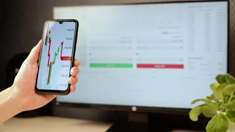 Close-up  businessman analyzing graph of stock exchange market using mobile app Stock-Footage 166431775