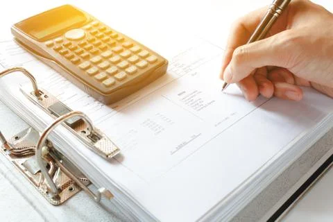Close-up of a Businessman Analyzing Writing note accounting document with c.. Stock Photos