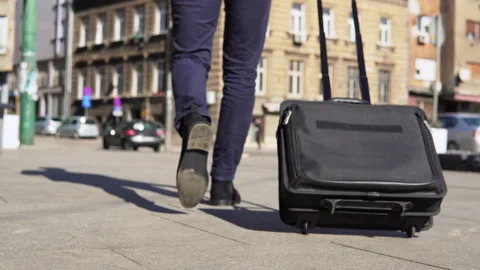 Close up of businessman carrying suitcase while walking outside of the airpor Stock Footage 171679558