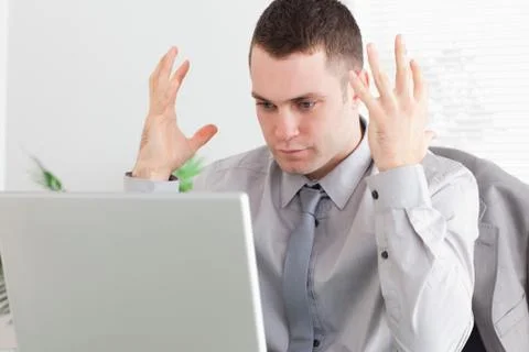 Close up of businessman experiencing problems with his laptop Foto stock
