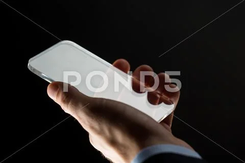 Close up of businessman with glass smartphone Stock Photos