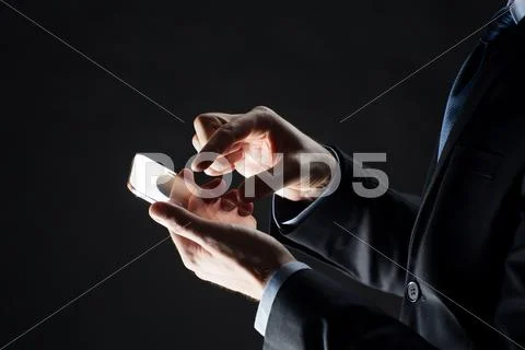 Close up of businessman with glass smartphone Stock Photos