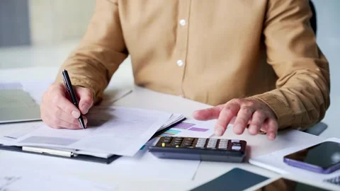 Close-up of a businessman hands completing financial paperwork on a clipboard  Stock Footage 342017679