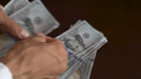 Close-up of a businessman hands counting hundred dollar bills at table Stock Footage 66691509