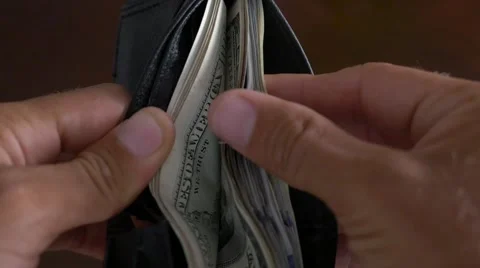 Close-up of a businessman hands counting hundred dollar bills in wallet Stock Footage 66691827
