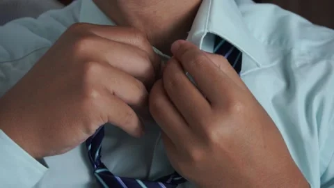 Close up of a businessman hands fixing or adjusting a striped blue necktie Video stock 337760911