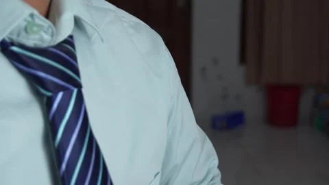 Close up of a businessman hands fixing or adjusting a striped blue necktie Video stock 337760997