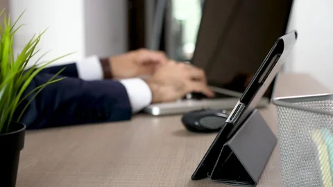 Close up businessman hands using a tablet PC in his office Stock Footage 93601242