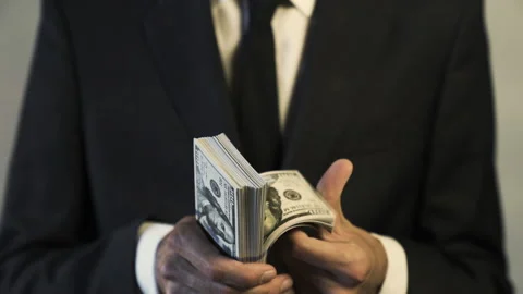 Close up of Businessman Holding a Big Stack Bundle of $100 Bills Money in Hands Stock Footage 134192534