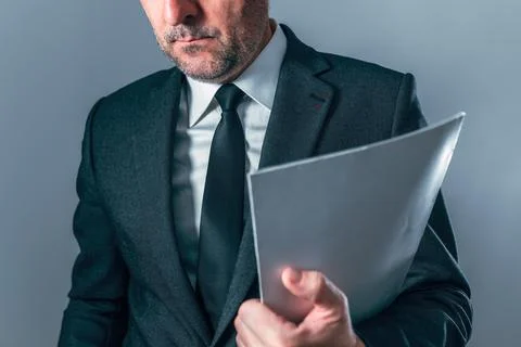 Close-up of businessman holding empty folder, symbolizing documentation, ad.. Stock Photos