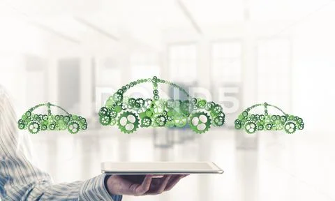Close of businessman holding tablet pc with car icon on screen Stock Photos