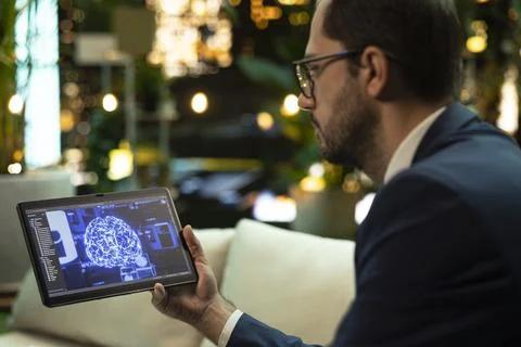 Close up of businessman interacting with AI interface on tablet Foto stock