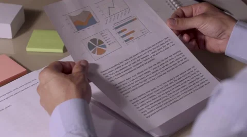 Close-up of businessman looking through the documents from his document case Видео 68791525
