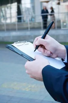Close up. businessman making notes on the clipboard Stock Photos