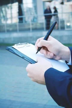 Close up. businessman making notes on the clipboard Stock Photos