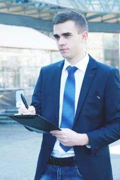Close up. businessman making notes on the clipboard Stock Photos