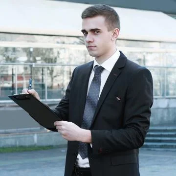 Close up. businessman making notes on the clipboard Stock Photos