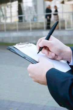 Close up. businessman making notes on the clipboard Stock Photos