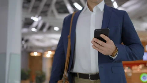 Close-up of businessman male hands using smartphone at shopping mall or office Stock Footage 166254445