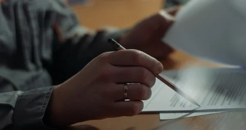 Close-up of a businessman man leafing documents with a pen in his hands Video stock 124783575