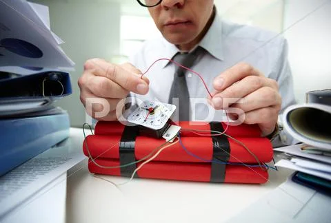 Close-up of businessman preparing bomb in office Stock-Fotos