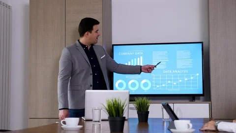 Close up of businessman presenting data on big screen TV Stock Footage 97521212