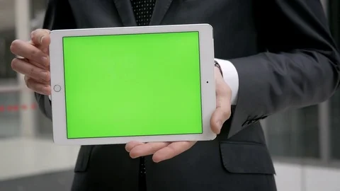 Close-up of businessman presenting something on a tablet with green screen Video stock 75947361