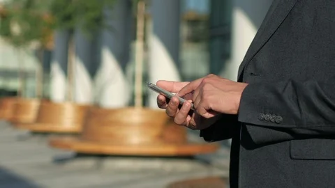 Close-up businessman sms texting using app on smart phone Stock Footage 94078356