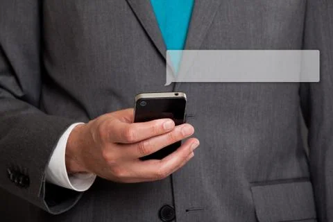 Close up of businessman text messaging on cell phone Stock Photos