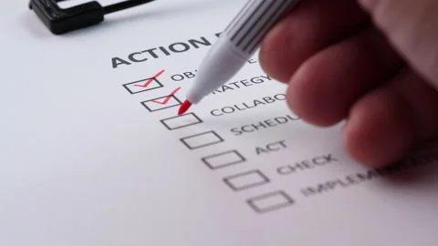Close-up businessman tick off or marking with red pen on action plan checklist 動画素材 201315979